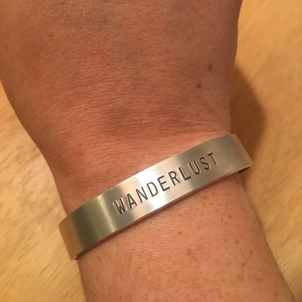 Handmade aluminum “wanderlust” engraved bracelet